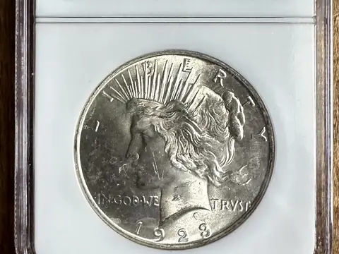 A 1923 Peace dollar in an NGC holder graded MS 63, labelled Binion Collection