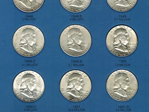 The first page of a Whitman coin folder filled with Franklin half dollars