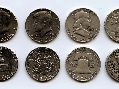 Eight US half dollars in two rows, faces above and backs below: a bicentennial Kennedy, a Kennedy, a Franklin and a Walking Liberty