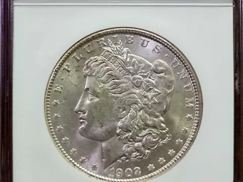 A 1902-O Morgan dollar in an NGC holder, graded MS 63